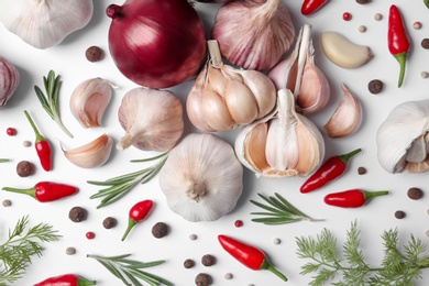 Composition with garlic, peppers and onions on white background, top view