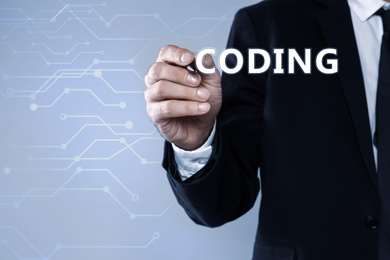 Image of Businessman pointing at word CODING on virtual screen, closeup 