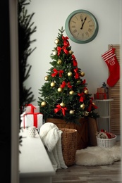 Stylish room interior with decorated Christmas tree