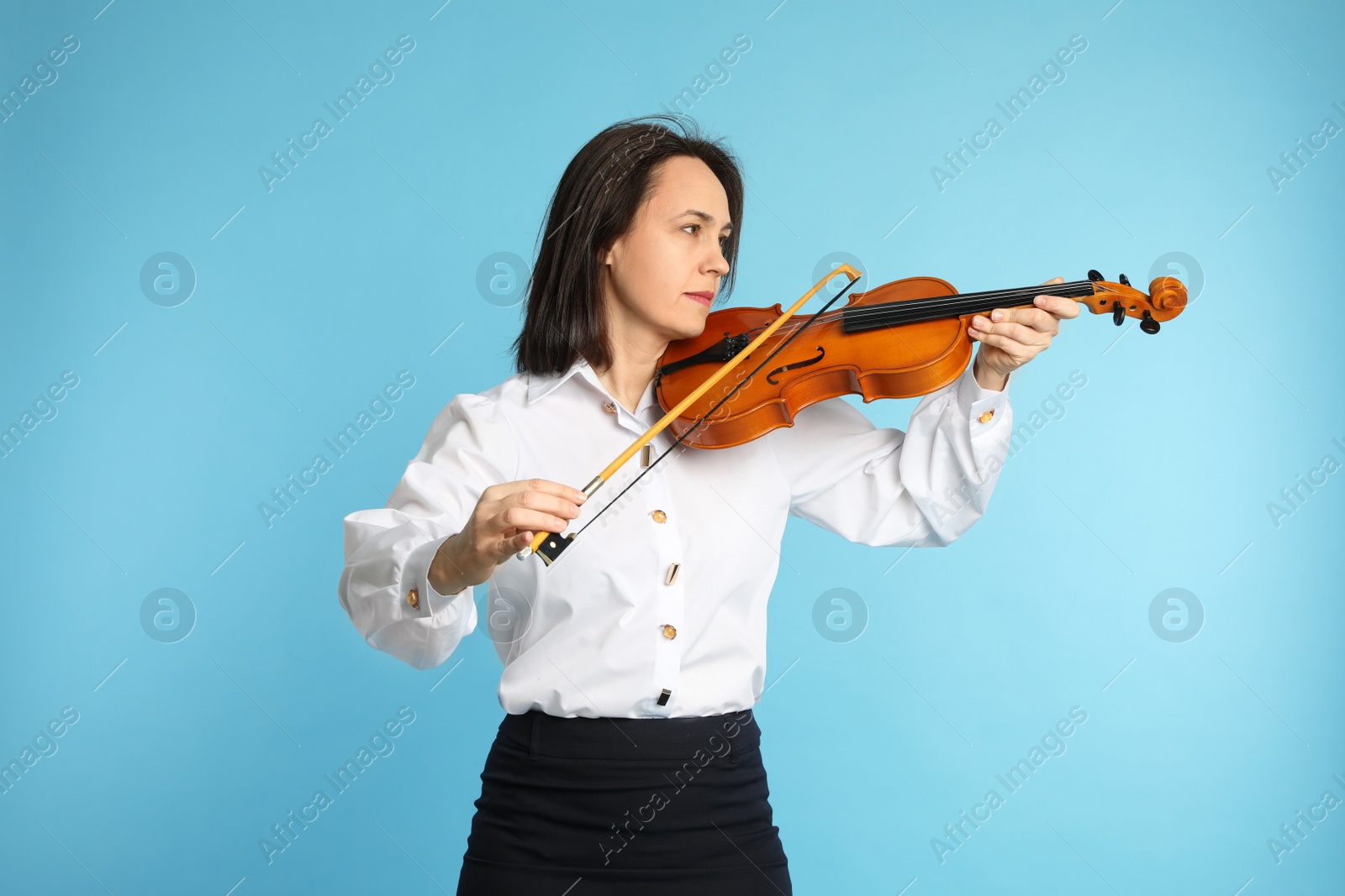 Photo of Music teacher playing violin on turquoise background