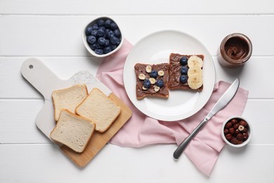 Photo of Different tasty toasts with nut butter and products on white wooden table, flat lay