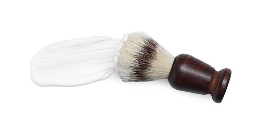 Shaving brush and foam on white background, top view