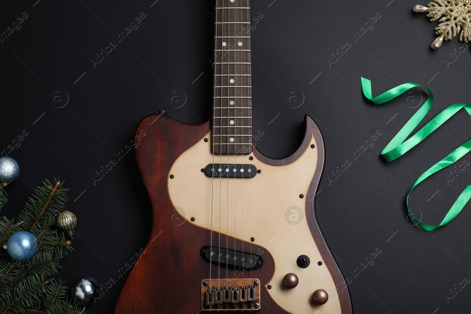 Photo of Christmas music. Flat lay composition with guitar on black background