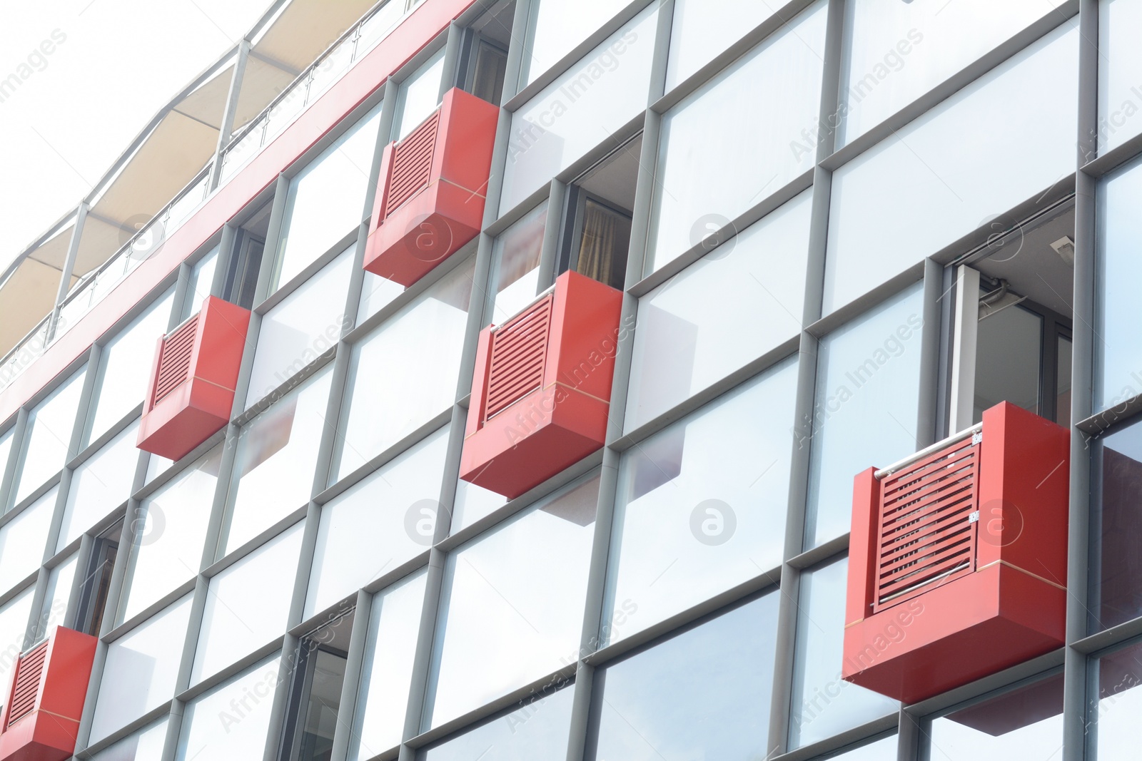 Photo of Exterior of beautiful modern residential complex with red small balconies