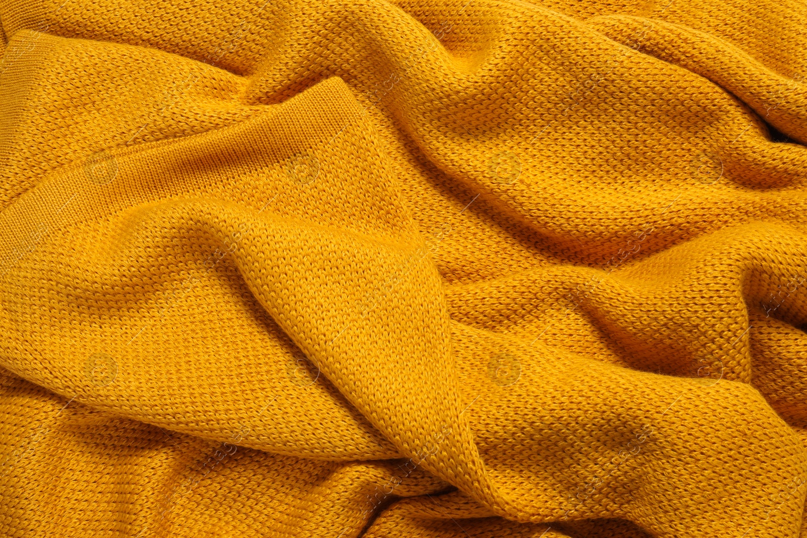 Photo of Texture of yellow knitted blanket as background