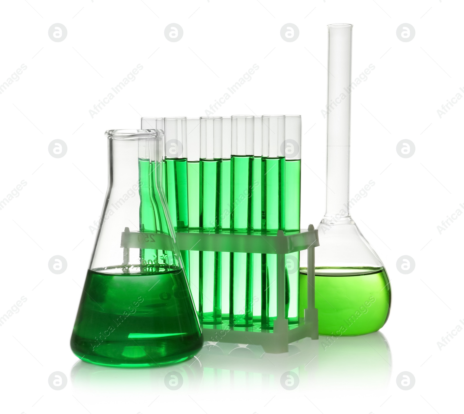 Photo of Laboratory glassware with green liquid on white background