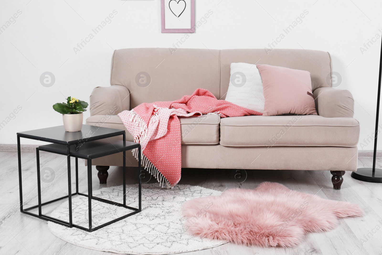 Photo of Comfortable sofa with pillows in modern living room interior