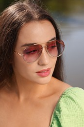 Photo of Beautiful woman in sunglasses outdoors on sunny day
