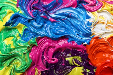 Photo of Mixed colorful acrylic paints as background, closeup view