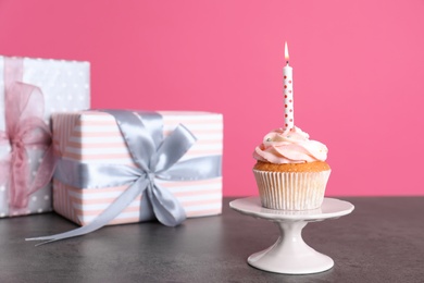 Composition with birthday cupcake and presents on table. Space for text