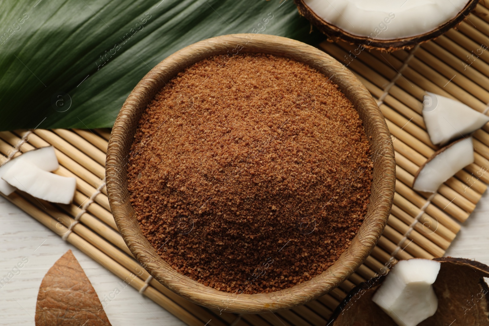 Photo of Flat lay composition with natural coconut sugar on white wooden table