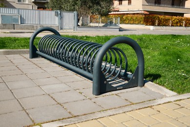 Photo of Empty metal bicycle parking rack on sunny day