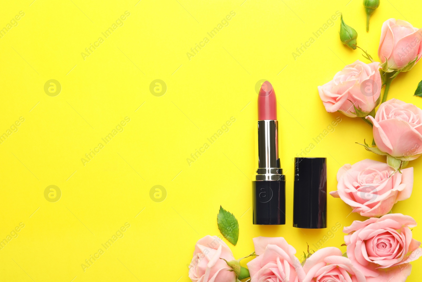 Photo of Flat lay composition with lipstick, roses and space for text on color background