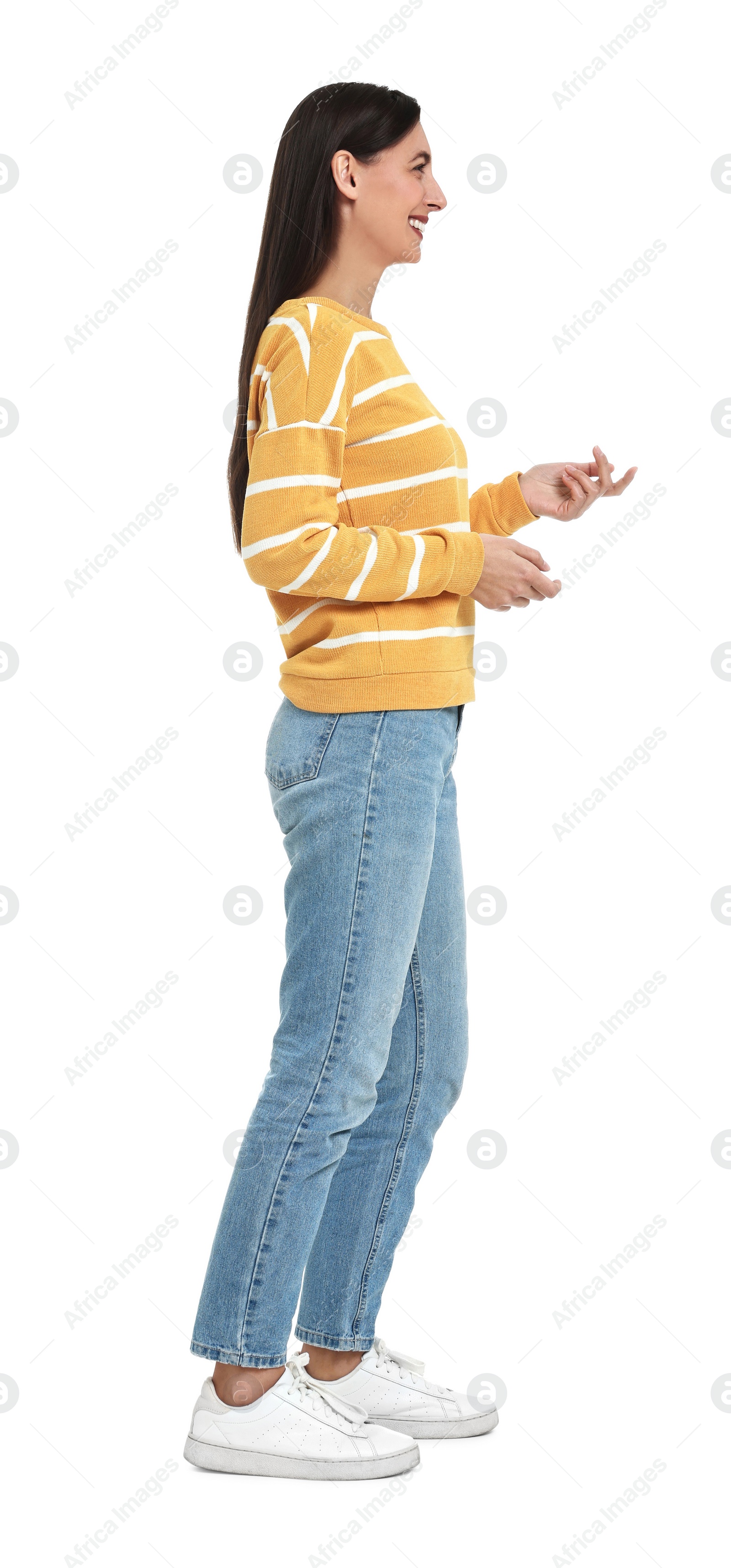 Photo of Happy woman in jeans and sweater on white background