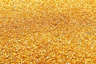 Texture of gold glitter as background, closeup