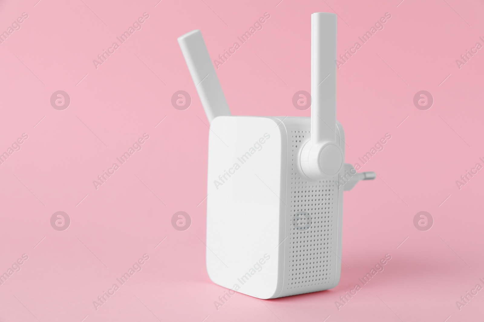 Photo of New modern Wi-Fi repeater on pink background, space for text