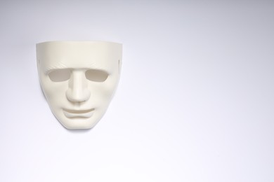 Theater arts. Plastic mask on white background, top view. Space for text