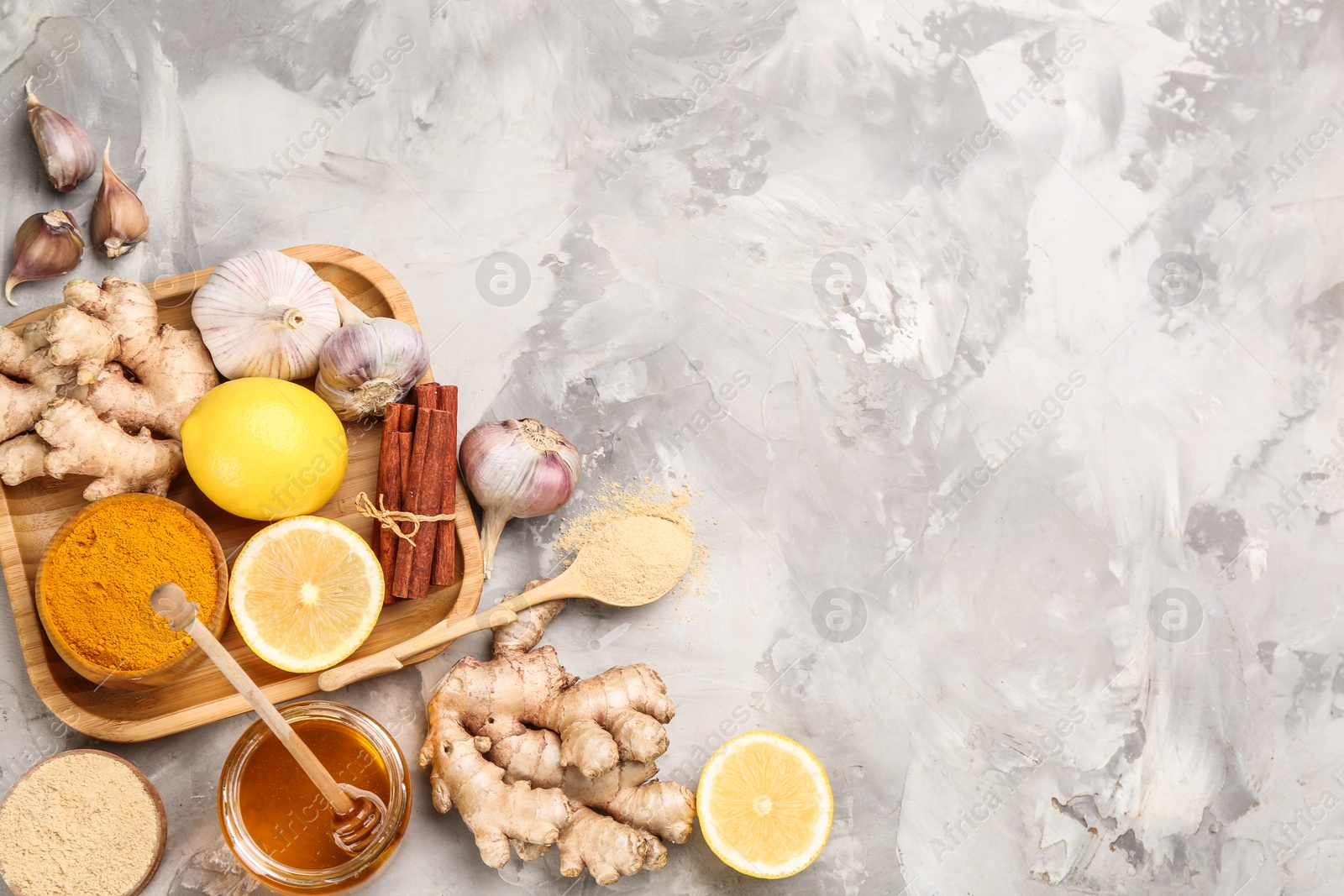 Photo of Flat lay composition with fresh products on grey table, space for text. Natural antibiotics