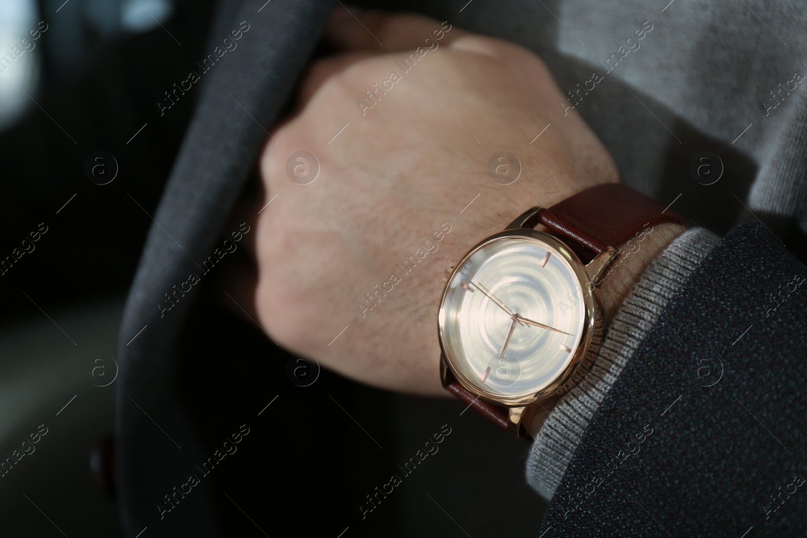 Photo of Man wearing luxury wrist watch with leather band, closeup