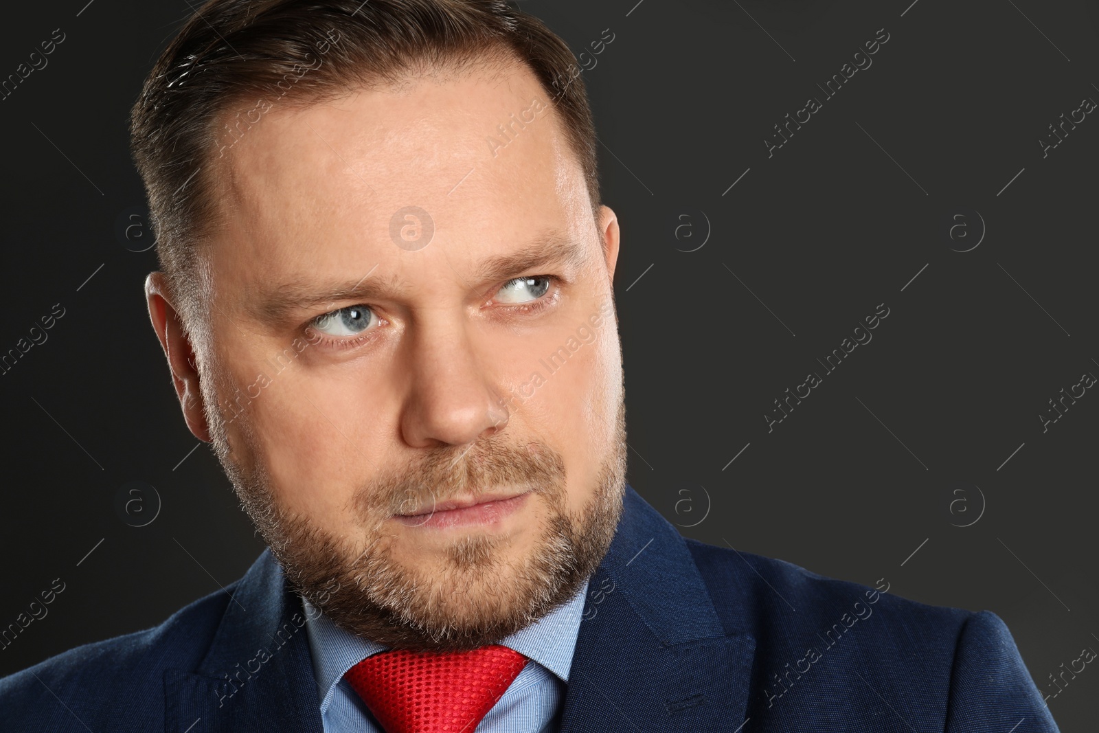 Photo of Portrait of mature man on black background