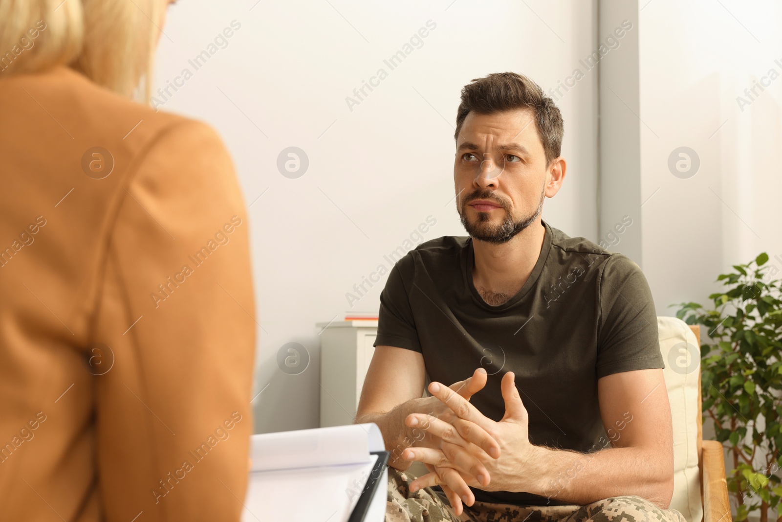 Photo of Psychologist working with military officer in office