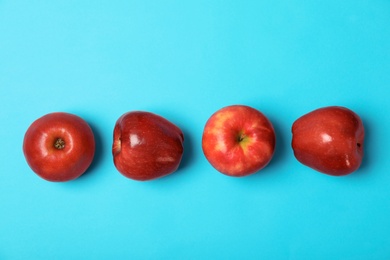Photo of Row of juicy red apples on color background