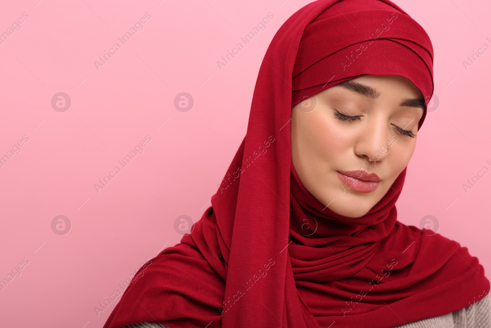 Photo of Portrait of Muslim woman in hijab on pink background