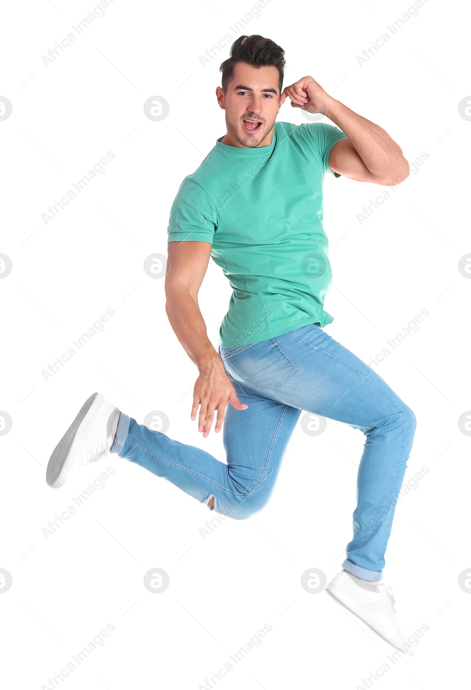 Photo of Young man in stylish jeans jumping on white background