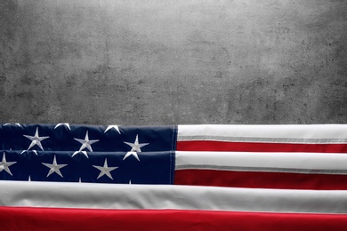 Photo of American flag on grey background, top view with space for text