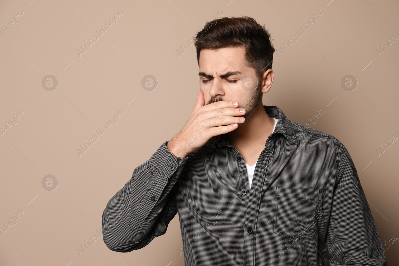 Photo of Handsome young man coughing against color background. Space for text