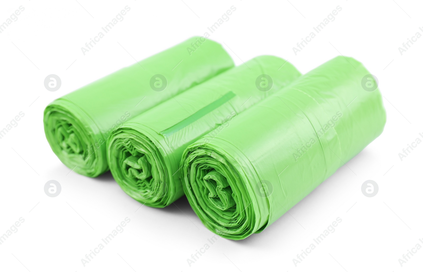 Photo of Rolls of light green garbage bags isolated on white