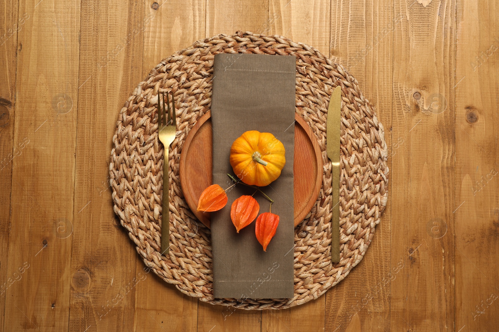 Photo of Autumn table setting, pumpkin and physalis, flat lay