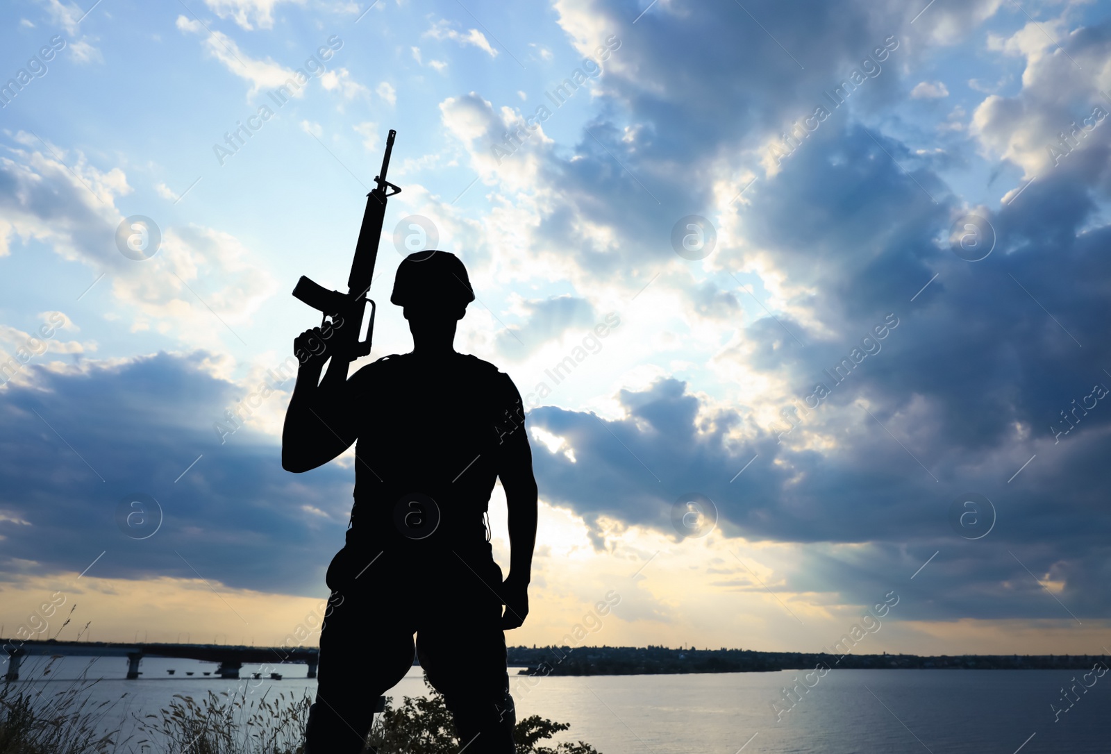 Photo of Soldier with machine gun patrolling outdoors. Military service