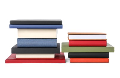 Many different hardcover books on white background