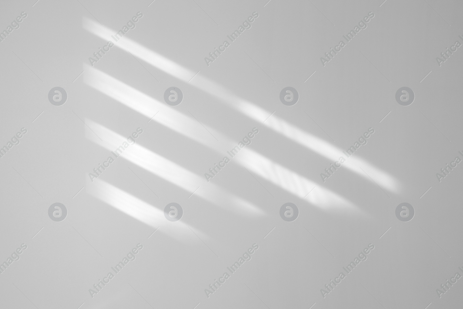 Image of Light and shadows falling on white wall