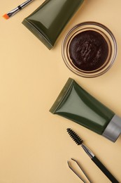 Photo of Flat lay composition with eyebrow henna and tools on beige background. Space for text