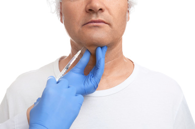 Mature man with double chin receiving injection on white background, closeup