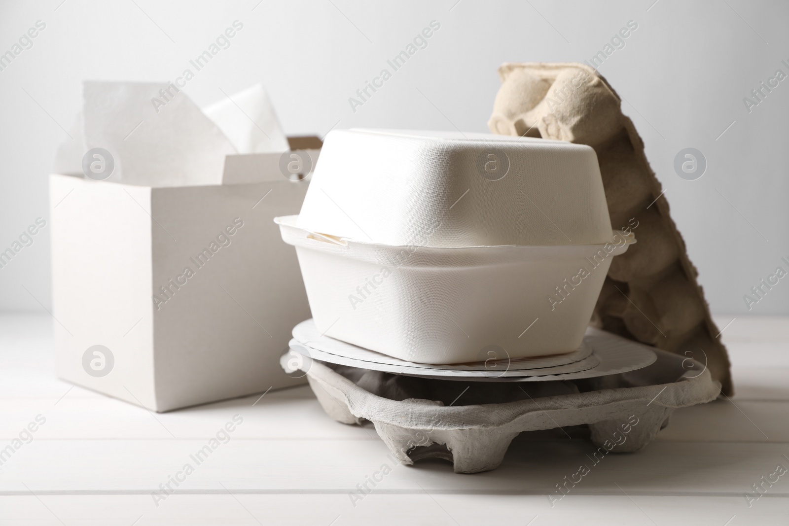 Photo of Heap of waste paper on white wooden table