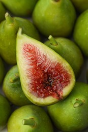 Photo of Cut and whole fresh green figs as background, top view
