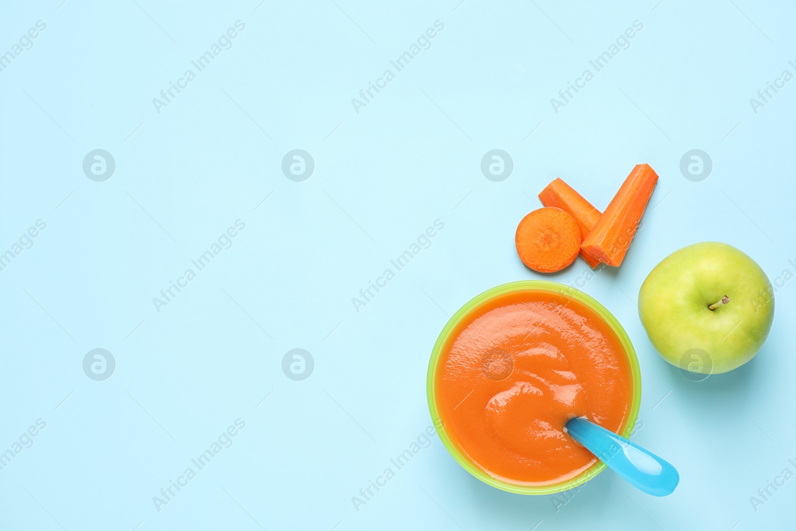 Photo of Healthy baby food and ingredients on light blue background, flat lay. Space for text