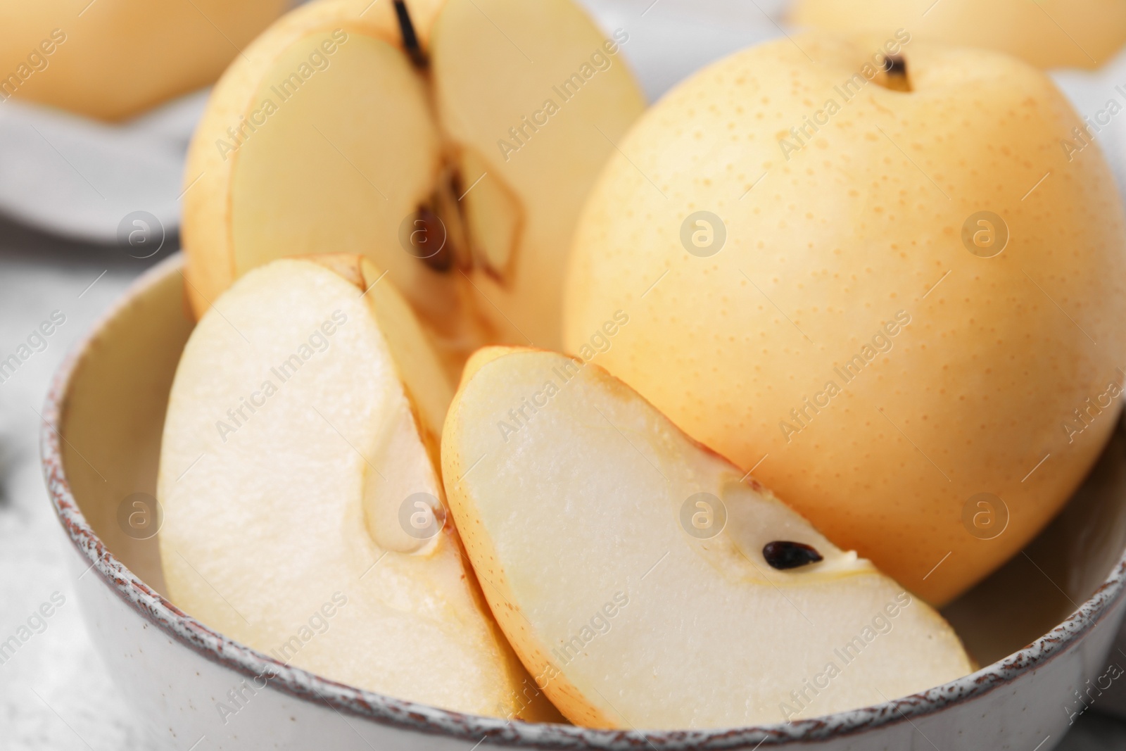 Photo of Delicious fresh apple pears in bowl, closeup