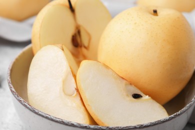 Delicious fresh apple pears in bowl, closeup