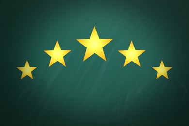 Image of Quality evaluation. Golden stars on green chalkboard