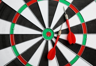 Photo of Dart board with color arrows, top view. Space for text