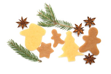 Photo of Unbaked Christmas cookies, anise and fir tree twigs on white background, top view