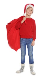 Photo of Cute little child in Santa hat with red Christmas bag on white background