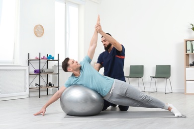 Physiotherapist working with patient in clinic. Rehabilitation therapy