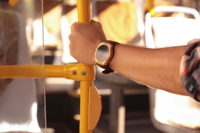 Photo of Man with smart watch in bus, closeup