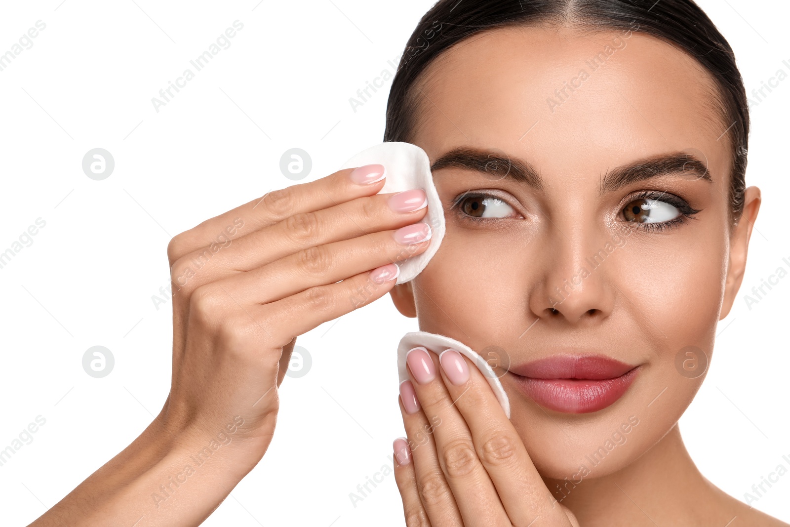 Photo of Beautiful woman removing makeup with cotton pads on white background