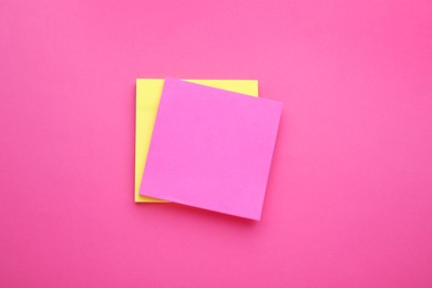 Photo of Paper notes on pink background, top view
